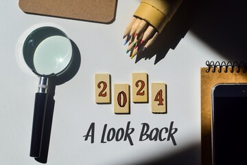 A look back at the year 2024 concept with wooden chips and inscription. Best of the year, highlights, review, performance, evaluation of 2024.