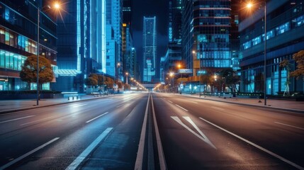 A city street at night with a lot of lights. The street is empty and the buildings are tall
