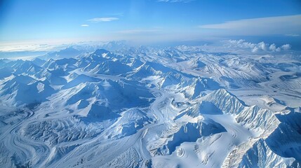 The sky is blue and the mountains are covered in snow. The snow is white and the mountains are tall
