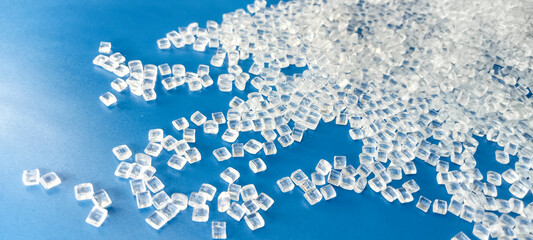 polymer plastic, virgin polymer resin granules type polycarbonte, isolated on blue background, for...