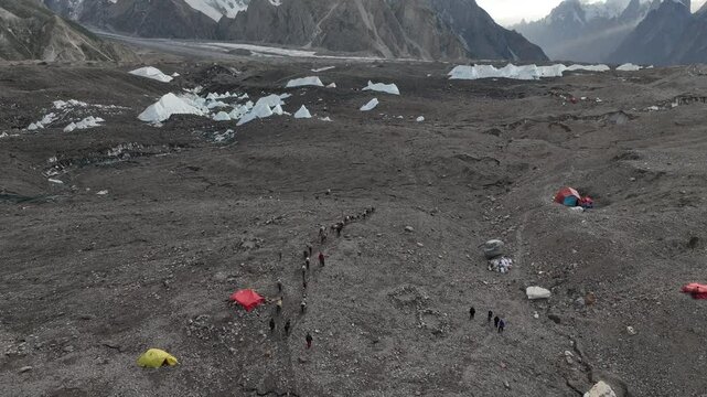 Hikers and donkeys leaving Goro 2 Campsite on the K2 Base Camp Trek in Pakistan.