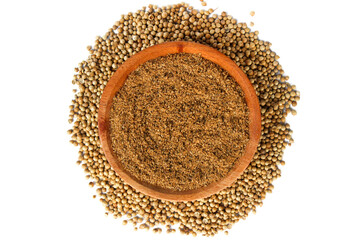 Coriander Powder on the small wooden plate isolated on a white background. Top view
