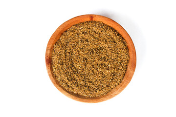 Coriander Powder on the small wooden plate isolated on a white background. Top view