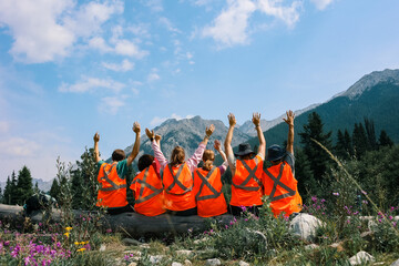 A Volunteer Group including young men and women wearing orange jackets with nature backgrounds.