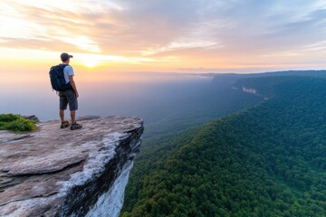 A hiker stands on a cliff, gazing at the breathtaking landscape during sunrise, inspired by nature's beauty and tranquility.