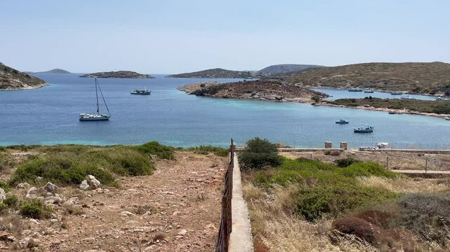 Greece, Arki Island, Porto Stretto, beautiful bay view, boats anchored , deep blue and turquoise sea, small islands.