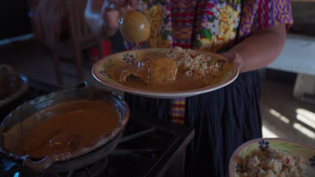 More recado is served to pepi&aacute;n blanco, a traditional dish from Guatemala. The rich white sauce gently drips over the ingredients, highlighting the creamy texture and deep flavor of the stew.