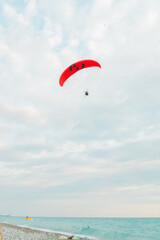 Paragliders far in the sky with clouds