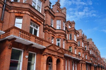 Long row of elegant brown brick townhouses in London