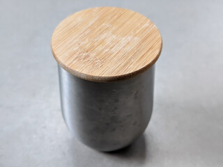 A close-up of an aluminum cup with a bamboo lid creates a unique fusion of modern and traditional...