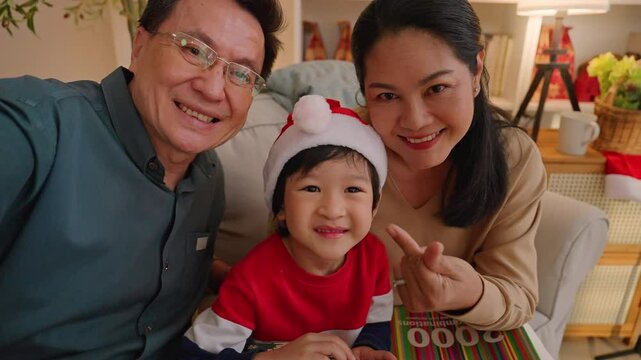 happiness asian family grandparent taking video phot selfie with grandson together in christmas eve thanksgiving celebrate family night with love and gathering multi generation relation in christmas 