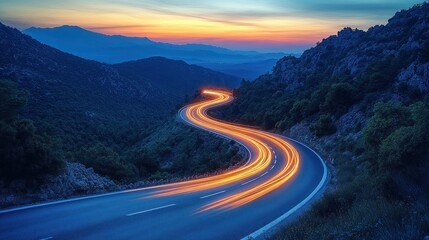 Serene winding road at sunset, illuminated by vehicle lights.