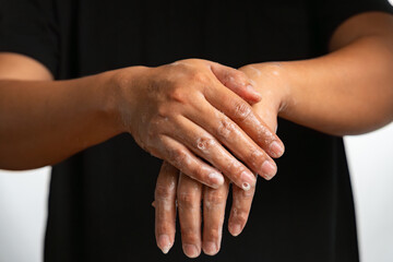 Man washing hands in white background, close-up