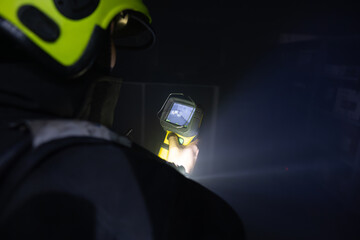 Firefighters use thermometer guns to measure heat