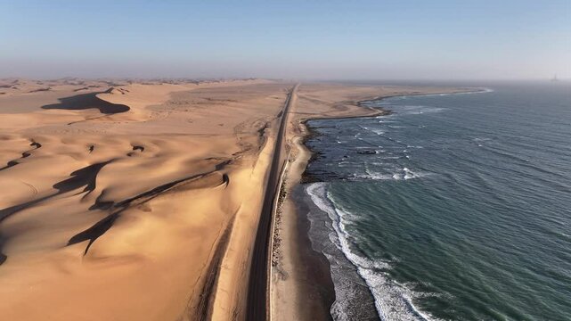 Aerial drone view over the beautiful dunes of Namibia near the coast on a beautiful sunset during an adventure trip to the African country