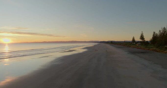 Rising over Ohope Beach at sunrise, Whakatane, New Zealand