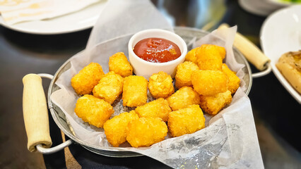 An appetizing image of crispy hash browns. Crispy Hash Browns with ketchup.