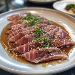 A plate of food with a piece of thinly sliced tuna