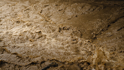 The fast-flowing river water is murky.