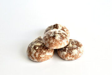 Gingerbread cookies in sugar glaze lie on a white background.