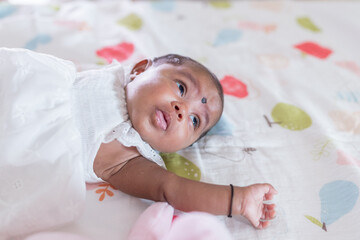 ndian family spending time together, wearing traditional and casual outfits with a baby, a young girl, and grandparents in a high-rise apartment in Kuala Lumpur, Malaysia.