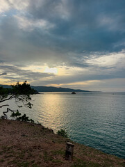 The sunset by the beach with the calm sea