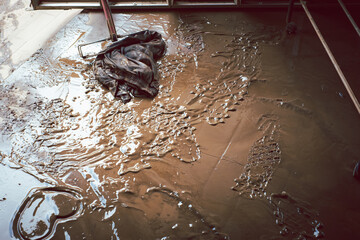 A dirty floor with a wet cloth on top of it