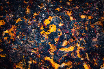 A close up of a rock with a lot of brown and orange colors. The rock appears to be weathered and...