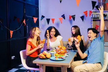 Friends celebrate indoors with food and wine, sharing laughs and toasts at a festive gathering.