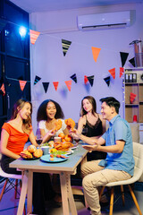 Friends celebrate indoors with food and wine, sharing laughs and toasts at a festive gathering.