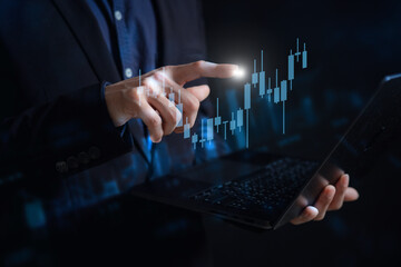 Fototapeta premium investment and finance concept, businessman touching virtual trading graph and blurred light on hand, stock market, profits and business growth.