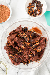 Top view of no-bake brownie batter with Halloween cookies in a bowl