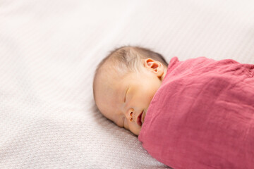 Adorable baby fall asleep on bed