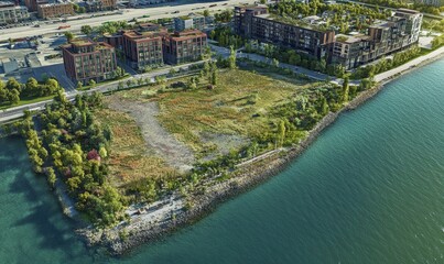 Aerial view of waterfront buildings and green space.