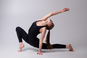 Beautiful flexible fit girl doing fit exercise. Sportive fit woman practicing yoga stretch split...