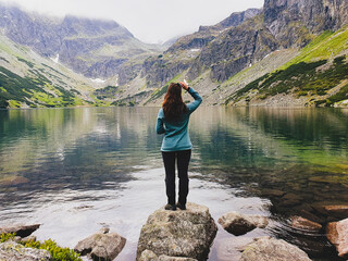 Beautiful brunette girl among fantastic mountain lake Morskie Oko © Bogdan