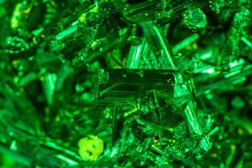 Green crystal mineral stone. Gems. Mineral crystals in the natural environment. Texture of precious and semiprecious stones. Seamless background with copy space colored shiny surface of precious stone