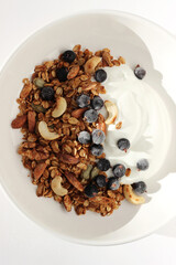 Breakfast. Greek Yoghurt with Fresh Granola, Almonds, Walnuts, Seeds, Cashew Nuts and Black Currants.