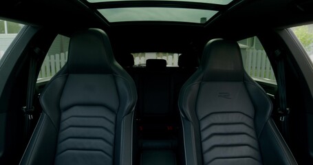 The man gets into the car, fastens his seat belt and starts driving. Front view from the car interior. Summer day © m-art