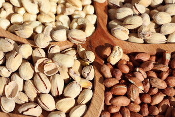 An assortment of nuts in wooden bowls offers a healthy and nutritious snack for all