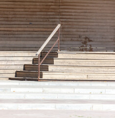 A staircase with a railing and a wooden handrail
