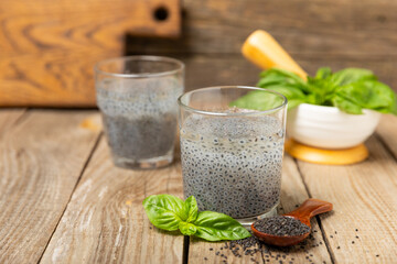 Basil seeds on textured wooden background. Close-up. Superfood. Ocimum basilicum. Organic basil seeds. selasih. Space for text. Copy space.