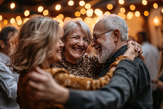 group of happy seniors dancing on a party