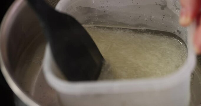 Mixing liquid gelatin or egg white in plastic container for cooking