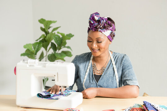 African american woman using a sowing machine
