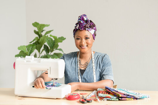 Beautiful Nigerian woman smiling while sowing