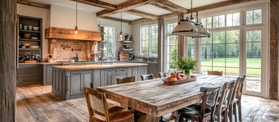 Rustic dining room with large windows overlooking a lush green lawn.