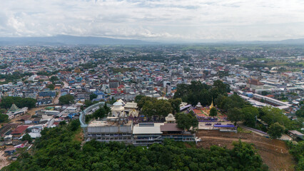 Aerial view of Wat Phrathat Doi Wao temple with Mae Sai downtown in the background. Mae Sai is the northern point in Thailand at the border to Myanmar.