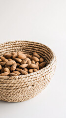Obraz premium closeup of a basket filled with almonds on white background