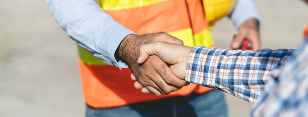 construction company handshaking with material supplier.